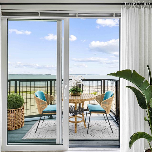 Ryder Revere Beach - Modern Balcony with Round Table and Two Blue Chairs