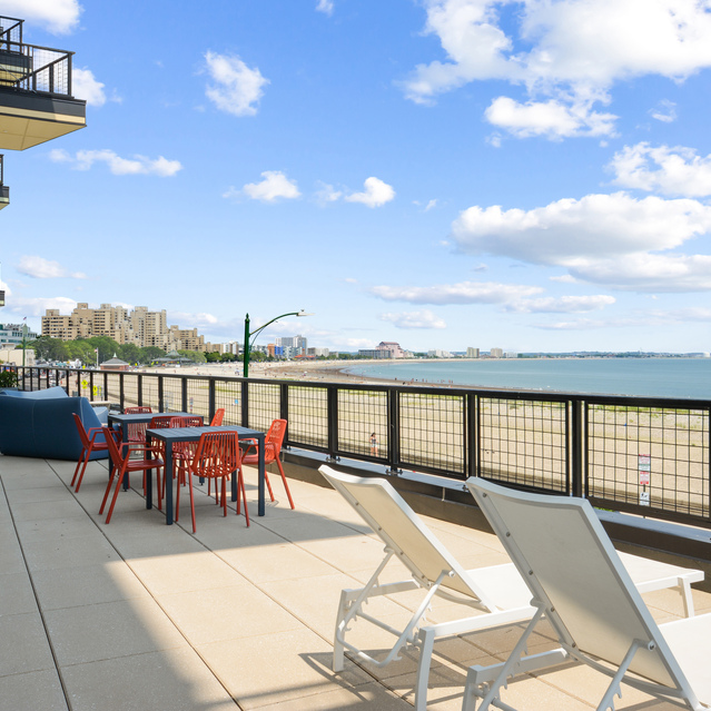 Ryder Revere Beach - Outdoor Patio With White Lounge Chairs