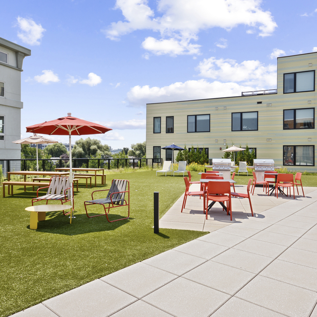 Ryder Revere Beach - Outdoor Courtyard With Red Chairs