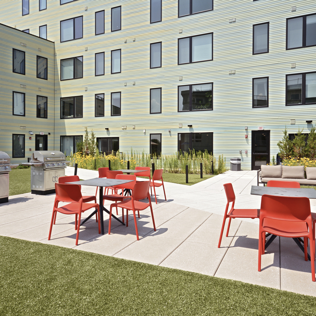 Ryder Revere Beach - Outdoor Courtyard With Red Chairs