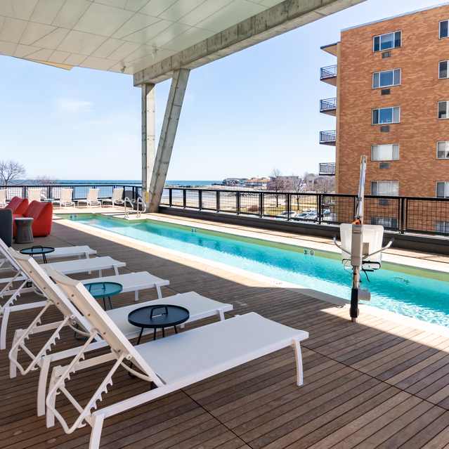 Ryder Revere Beach - Outdoor Pool Deck With White Lounge Chairs
