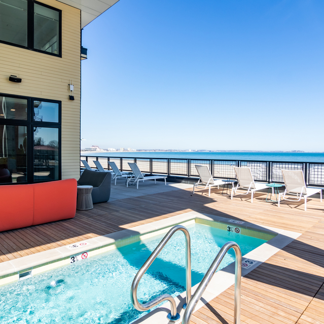 Ryder Revere Beach - Outdoor Pool Area With White Lounge Chairs